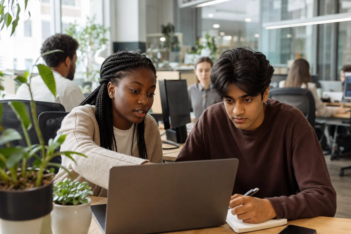 Two students collaborating on real work during their internship